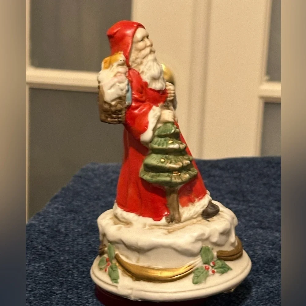 Revolving porcelain Santa musical figure plays Santa Claus is Coming to Town.